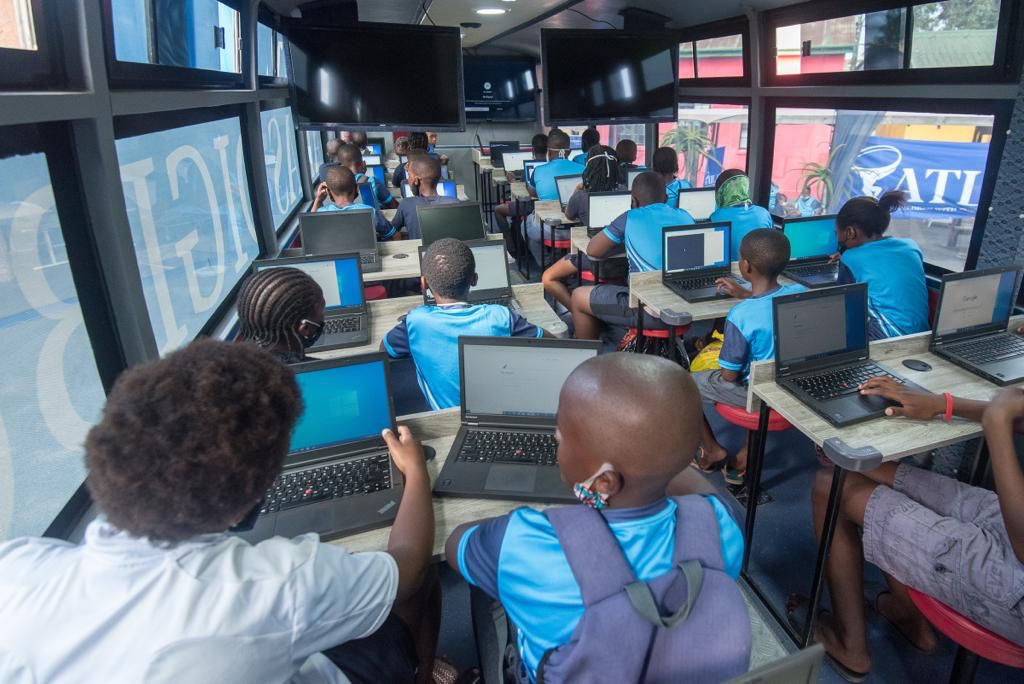 A full DigiBus classroom of learners working on laptops at their desks