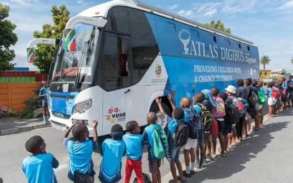 Learners queueing to board the Atlas DigiBus